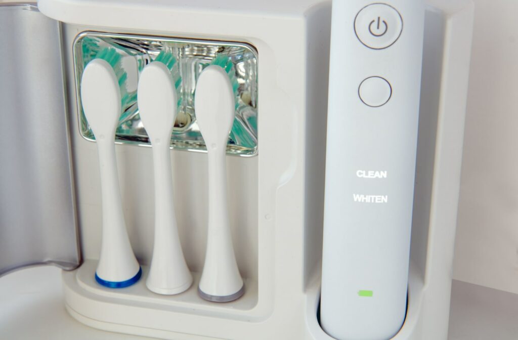 An electric toothbrush with replaceable attachments of toothbrush stored in a UV toothbrush sanitizer