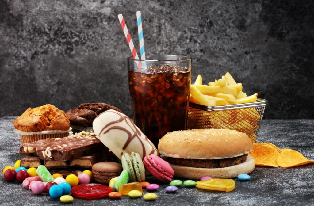 A collection of junk food including soda, pastries, and fast food items