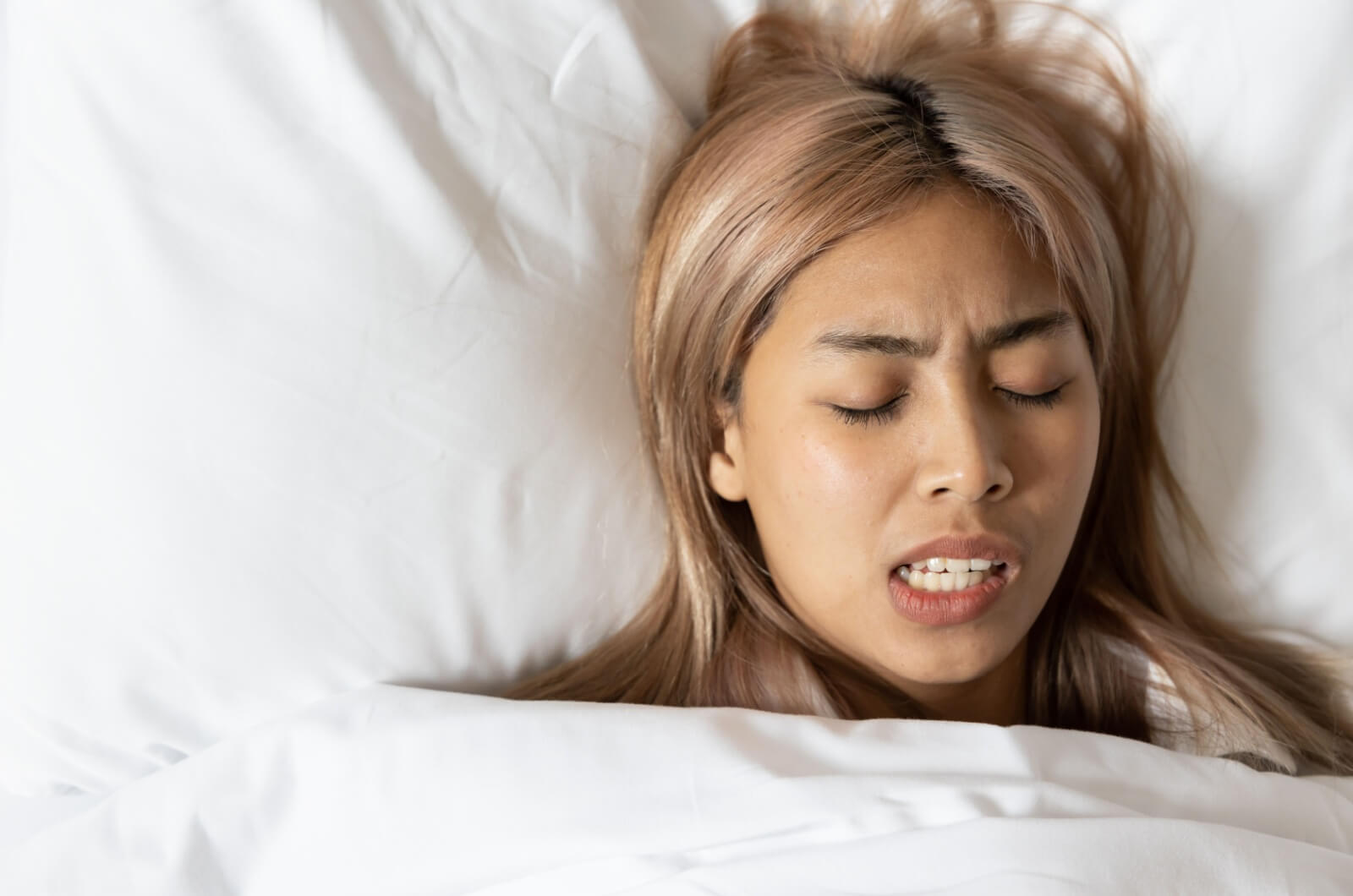 A young patient unknowingly grinding their teeth while sleeping.